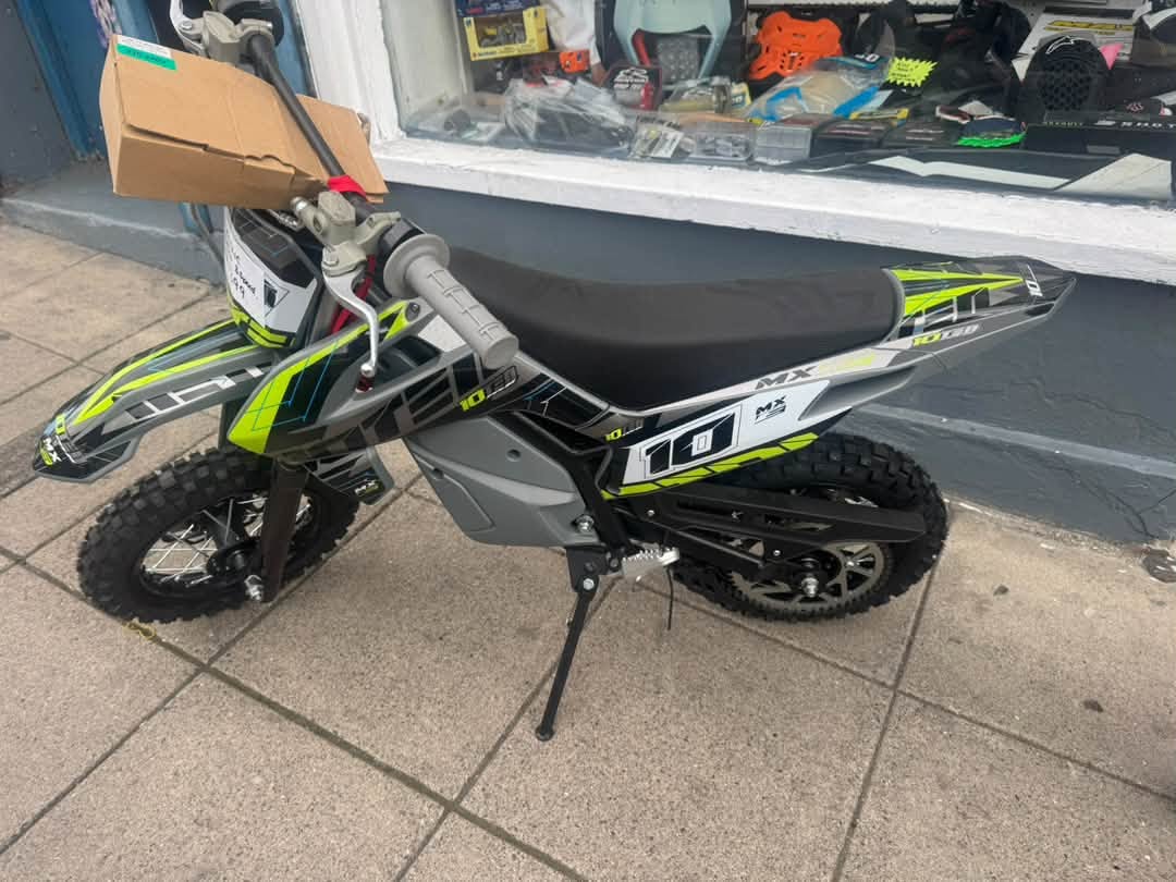 Kids electric ten ten bike in stock new May be an image of motorcycle, scooter, dirt bike and text. May be an image of motorcycle, dirt bike and text. May be an image of scooter, dirt bike, motorcycle and text